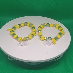 Yellow and Green Beaded Bracelets with White Flower